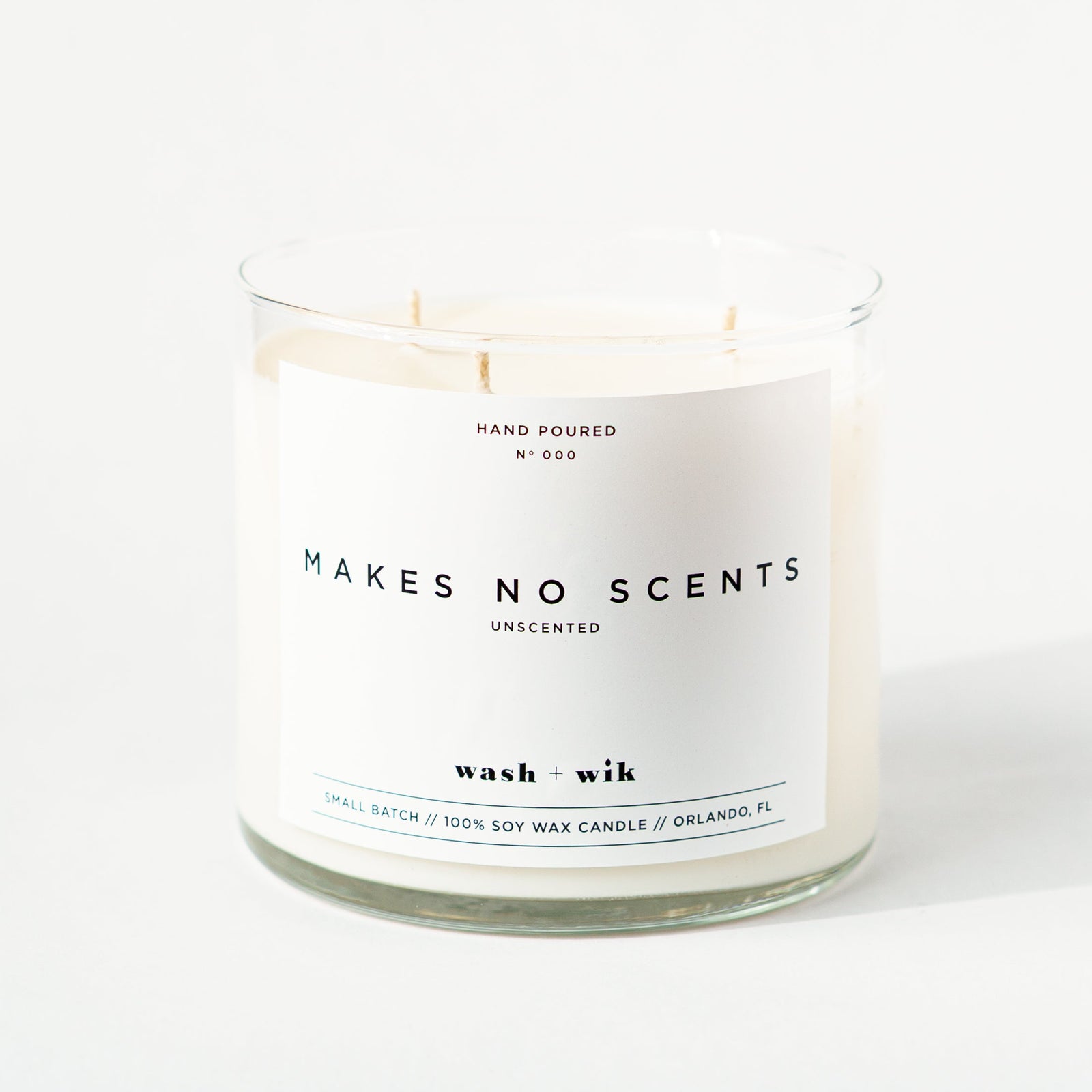 Unscented candle with 'Makes No Scents' label on a white background