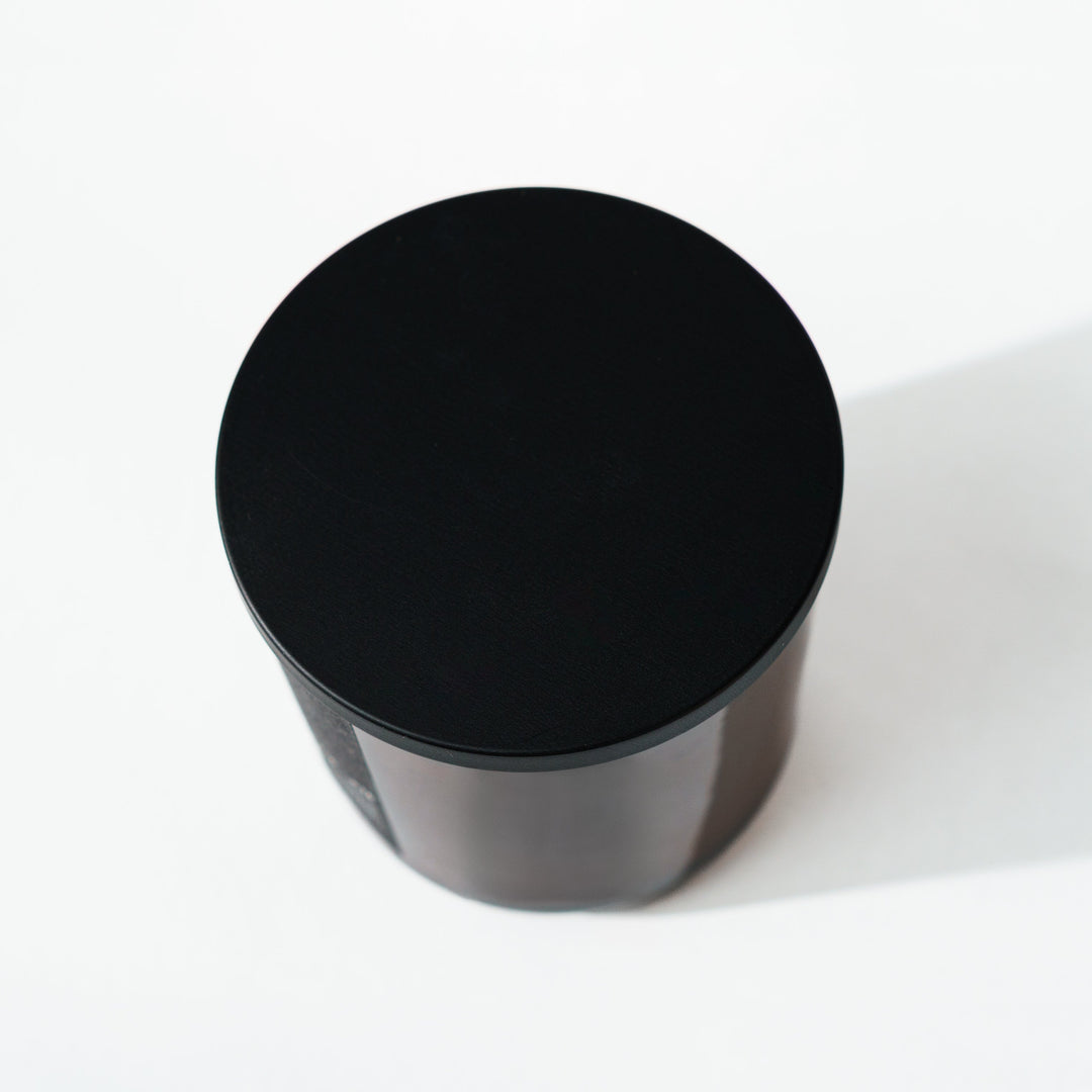 brown candle with black lid