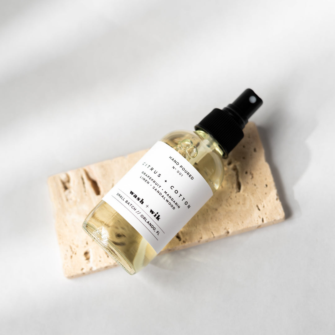 Bottle of wash milk with a label on a beige cloth against a white background