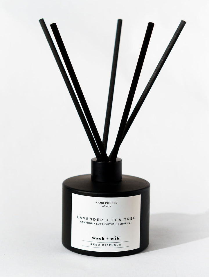 Black diffuser with sticks on a white background