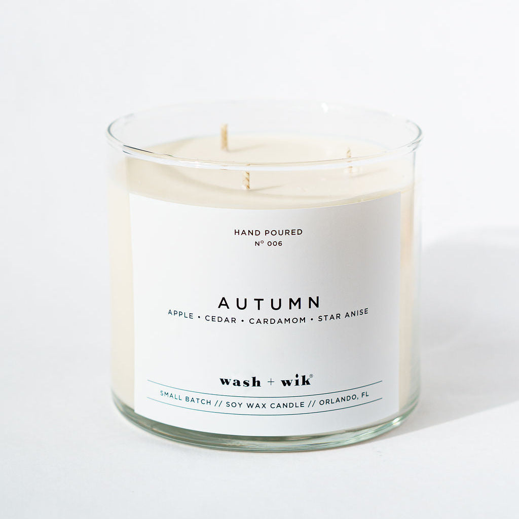 Candle labeled 'Autumn' by Wash & Wik on a white background