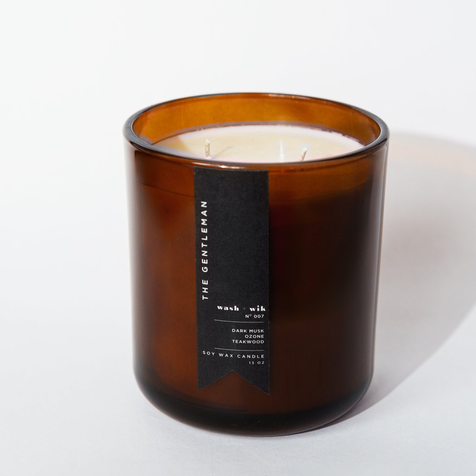 Brown candle with a label on a white background