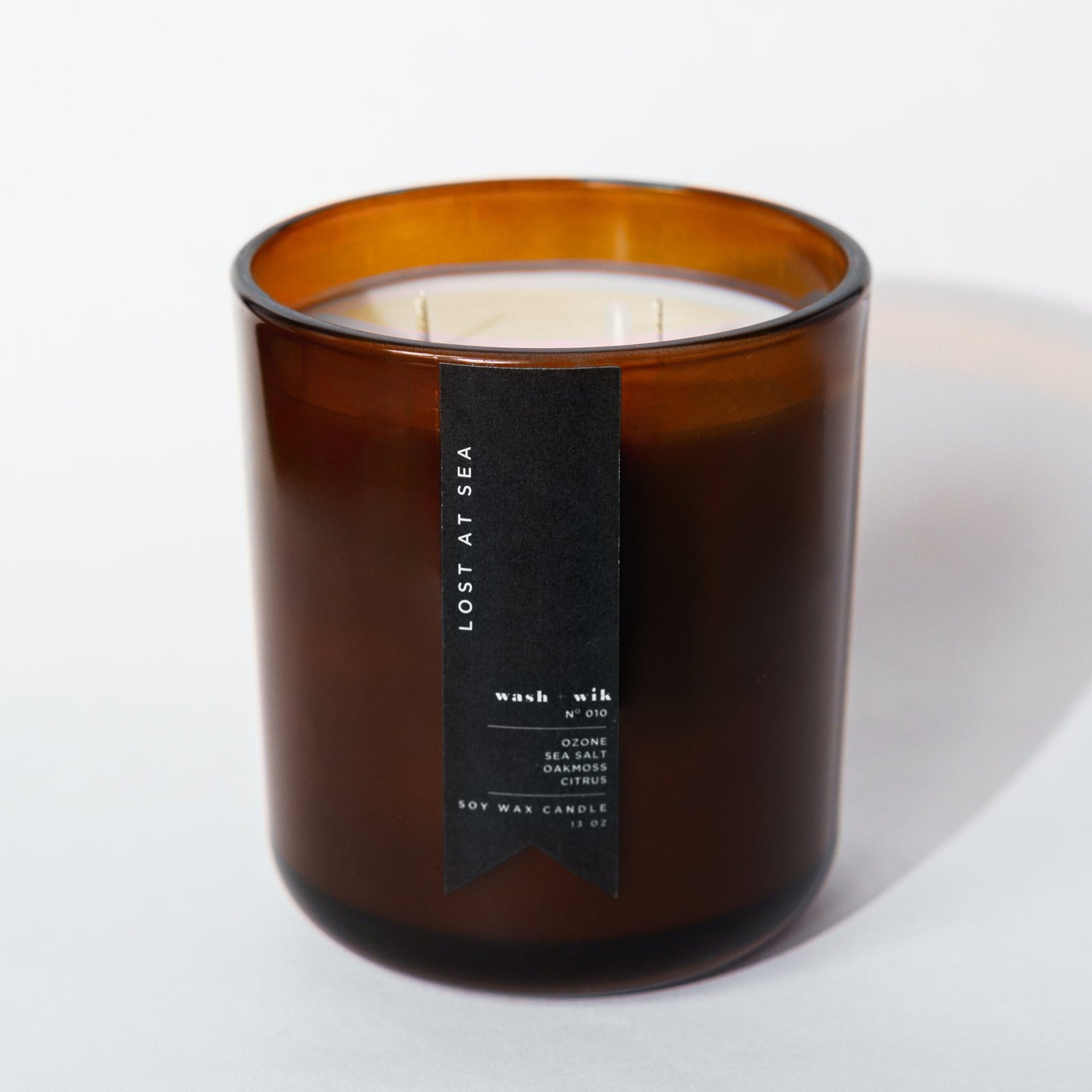 brown candle with black label and white background