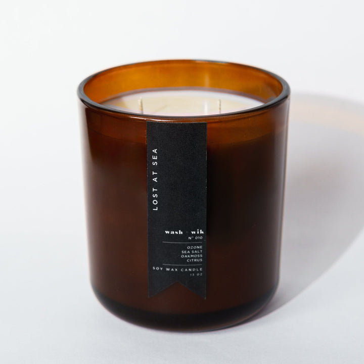 brown candle with black label and white background