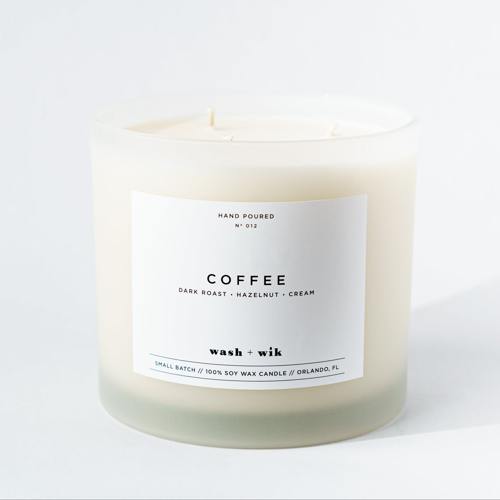 Candle labeled 'Coffee' on a white background