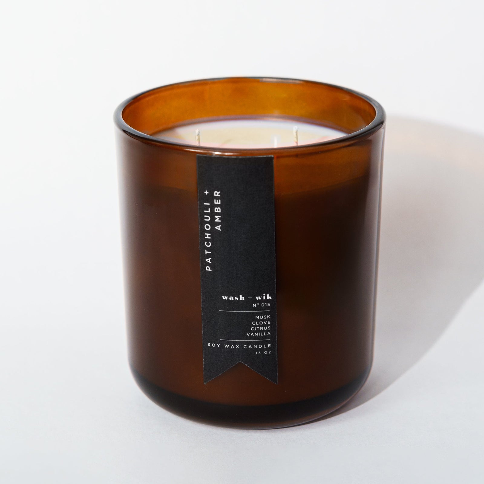 Brown candle with a label on a white background