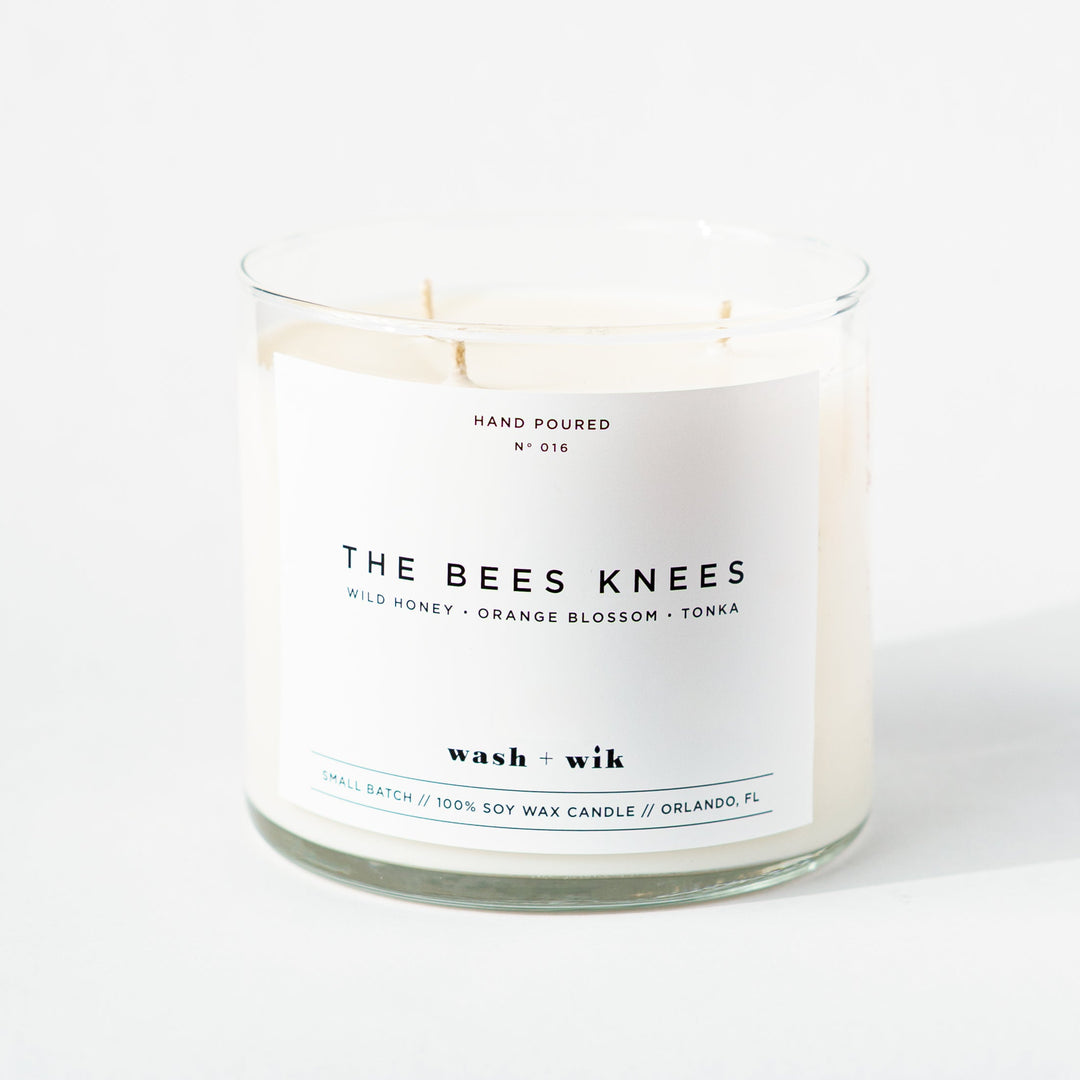 Candle in a glass jar with a label on a white background