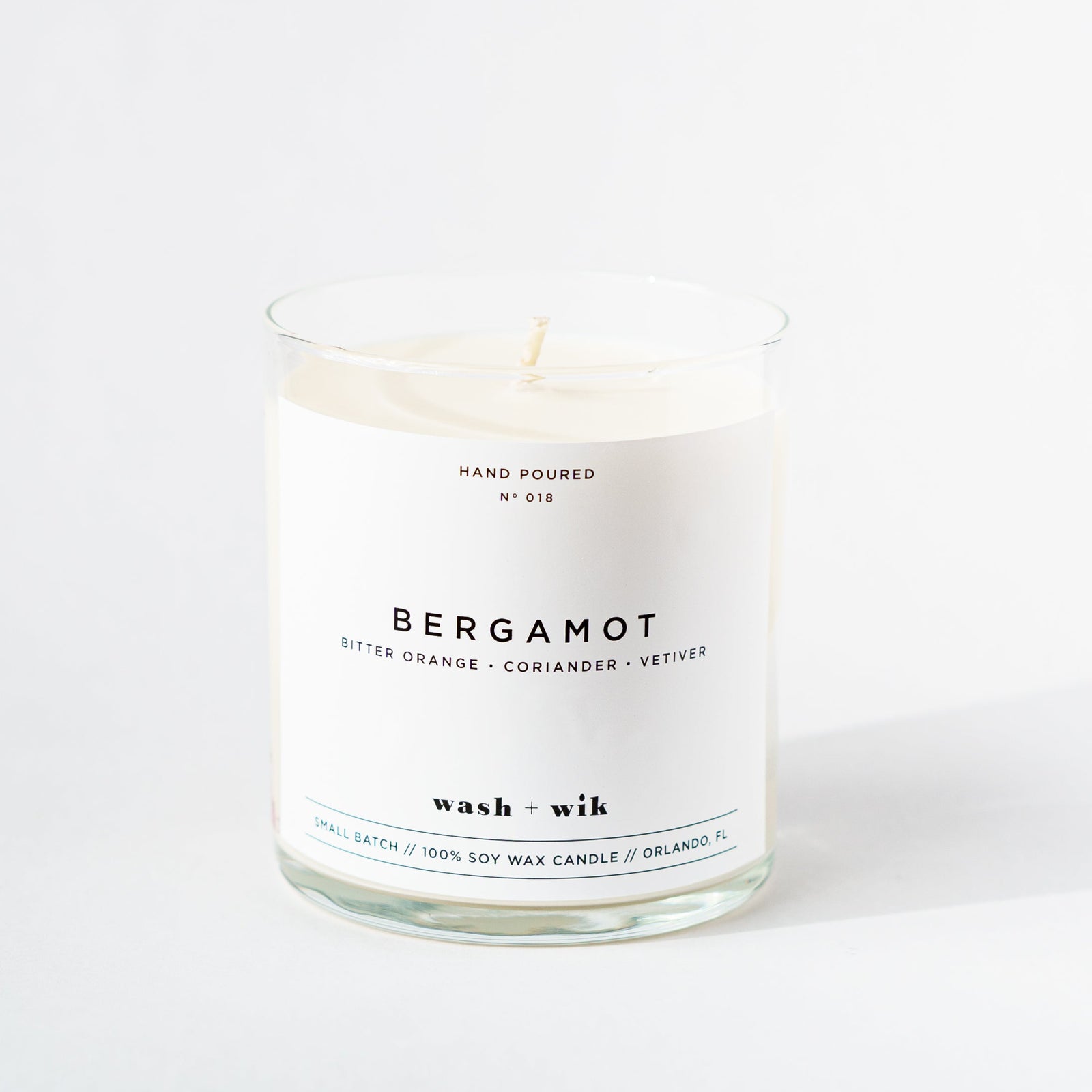 Candle with 'Bergamot' label on a white background