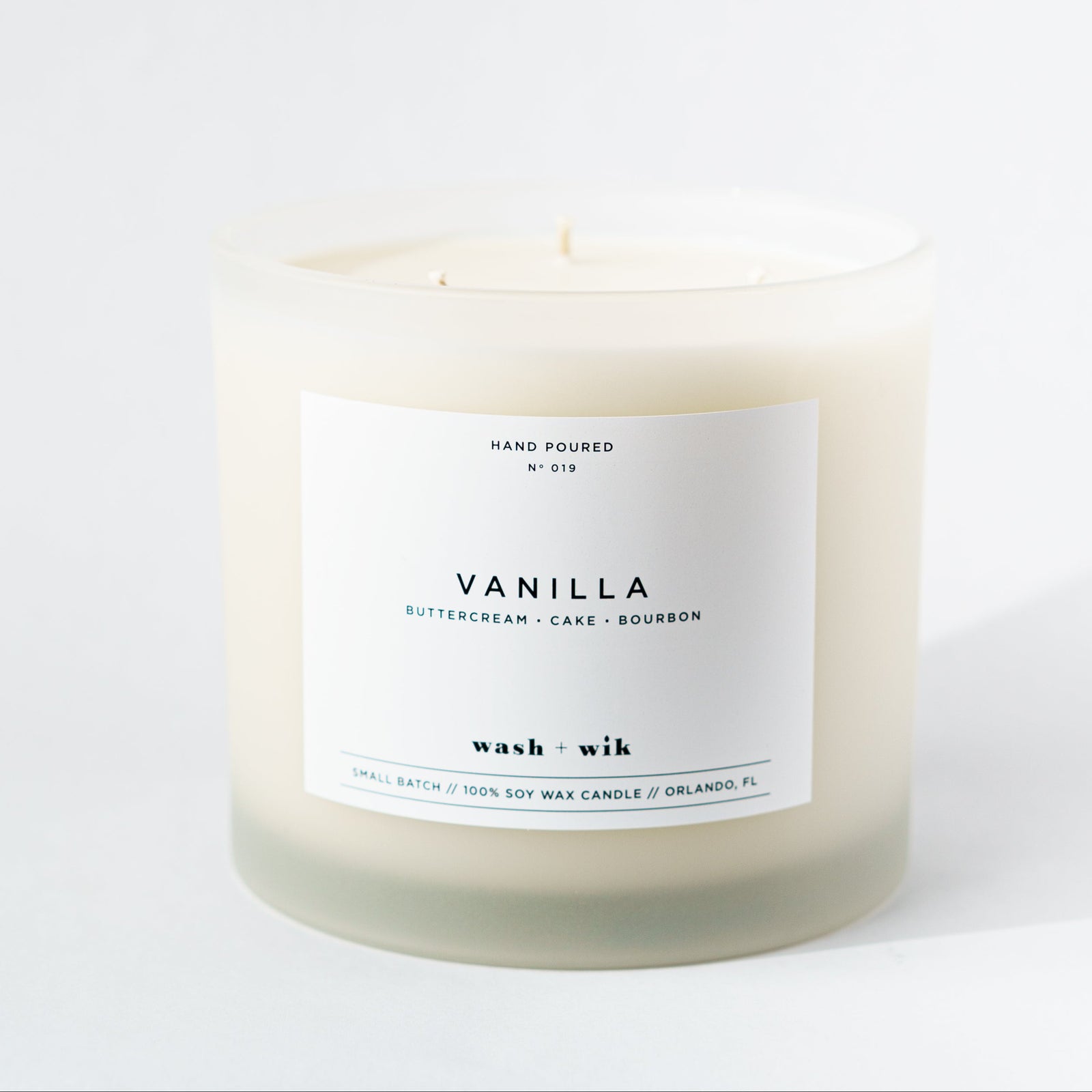 Vanilla candle with a white label on a white background