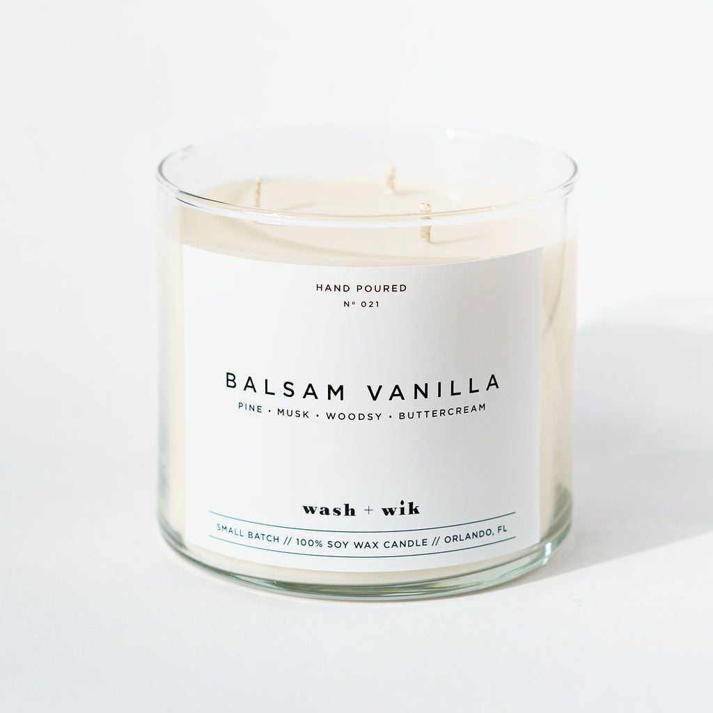 Candle with 'Balsam Vanilla' label on a white background