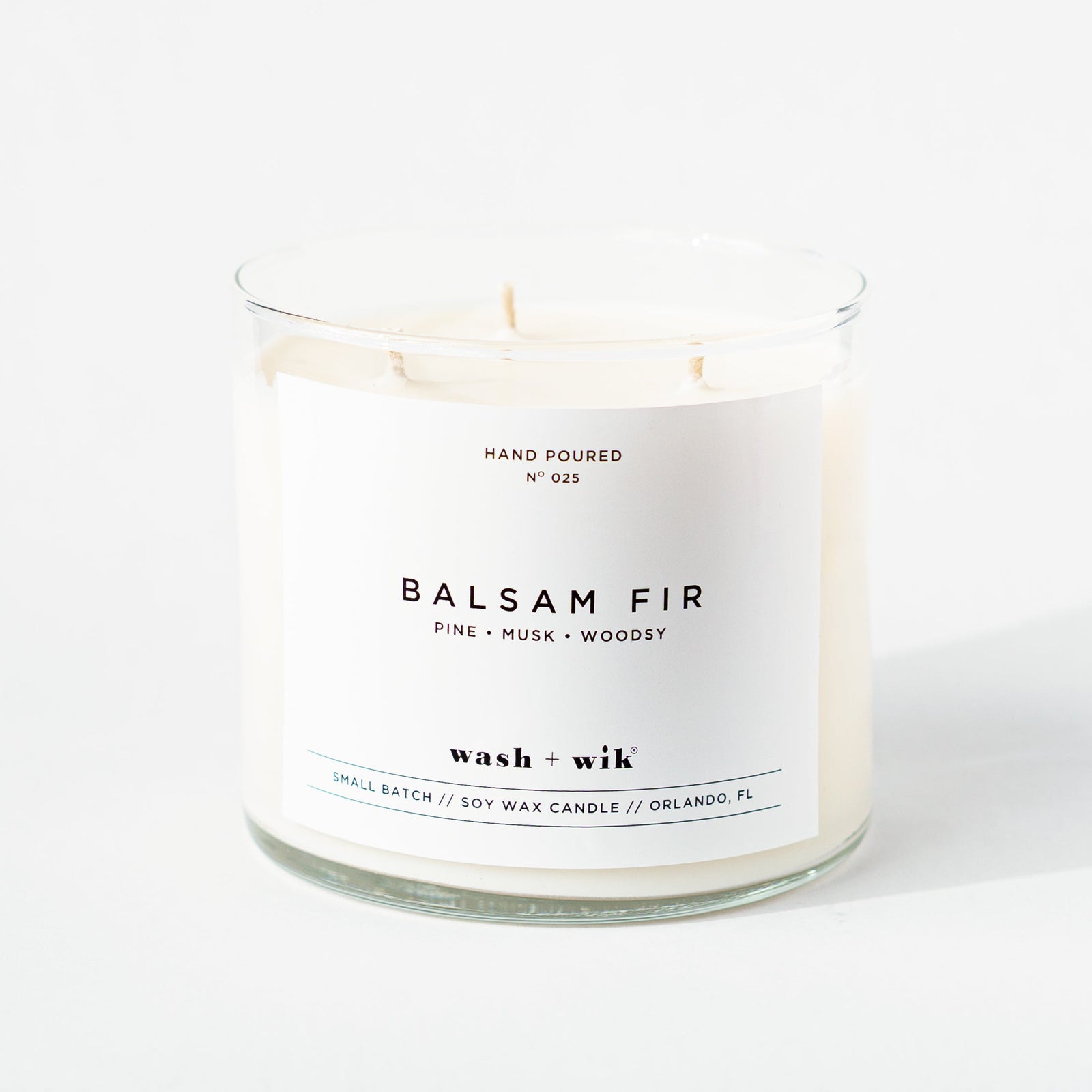 Candle with 'Balsam Fir' label on a white background