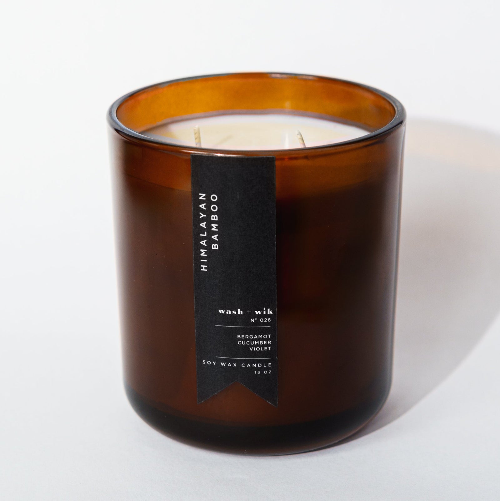brown candle with black label and white background