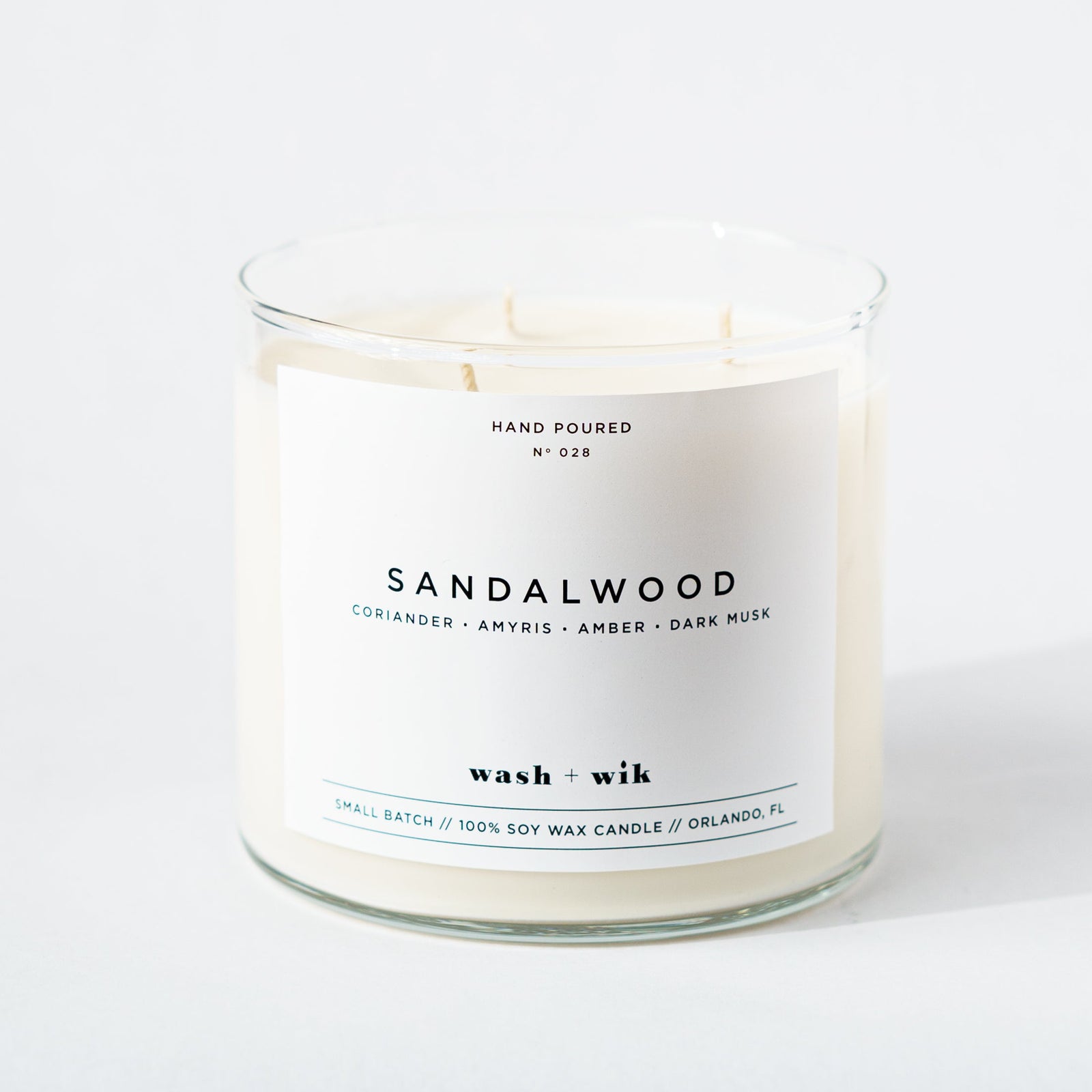 Sandalwood candle with a white label on a white background