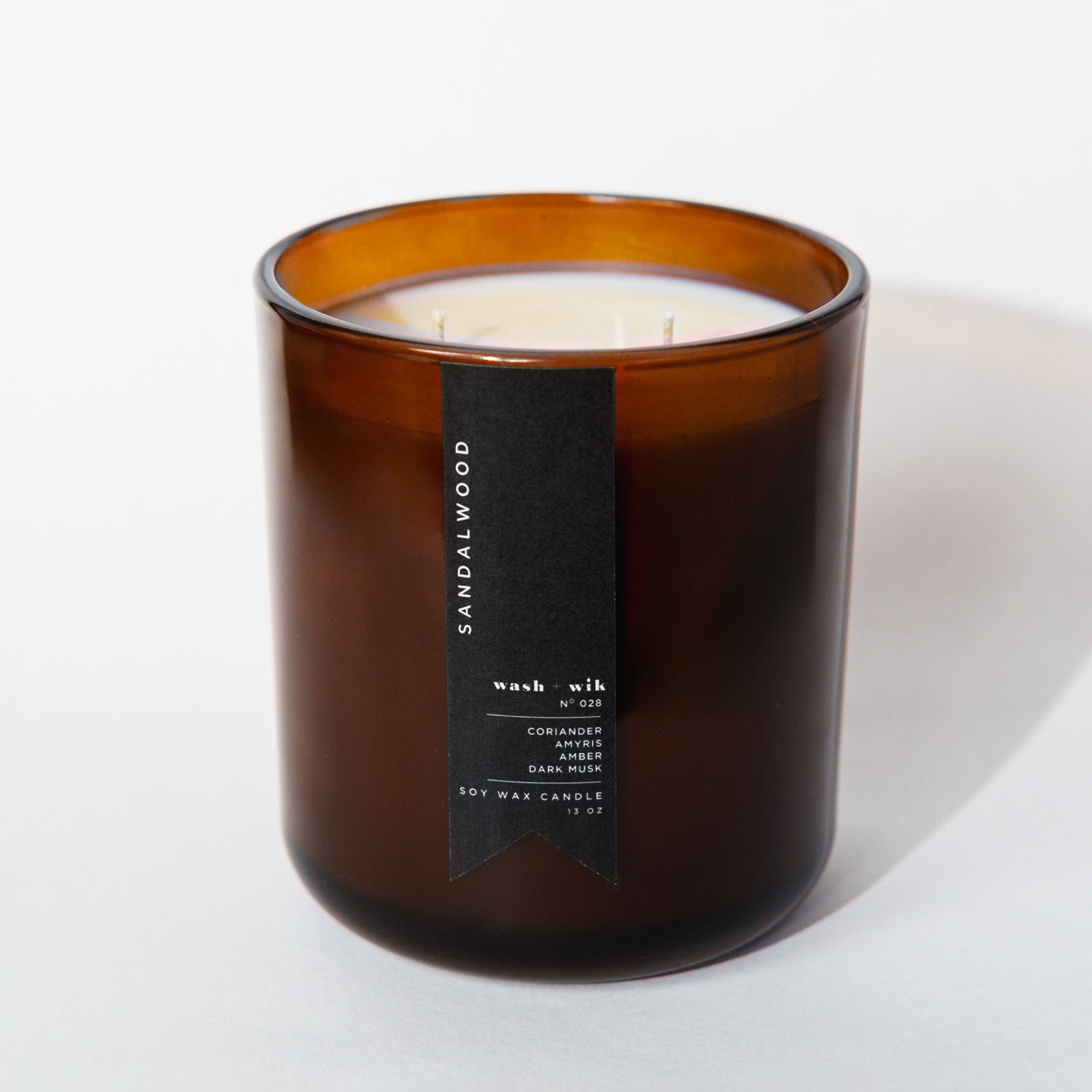 Brown candle with a label on a white background