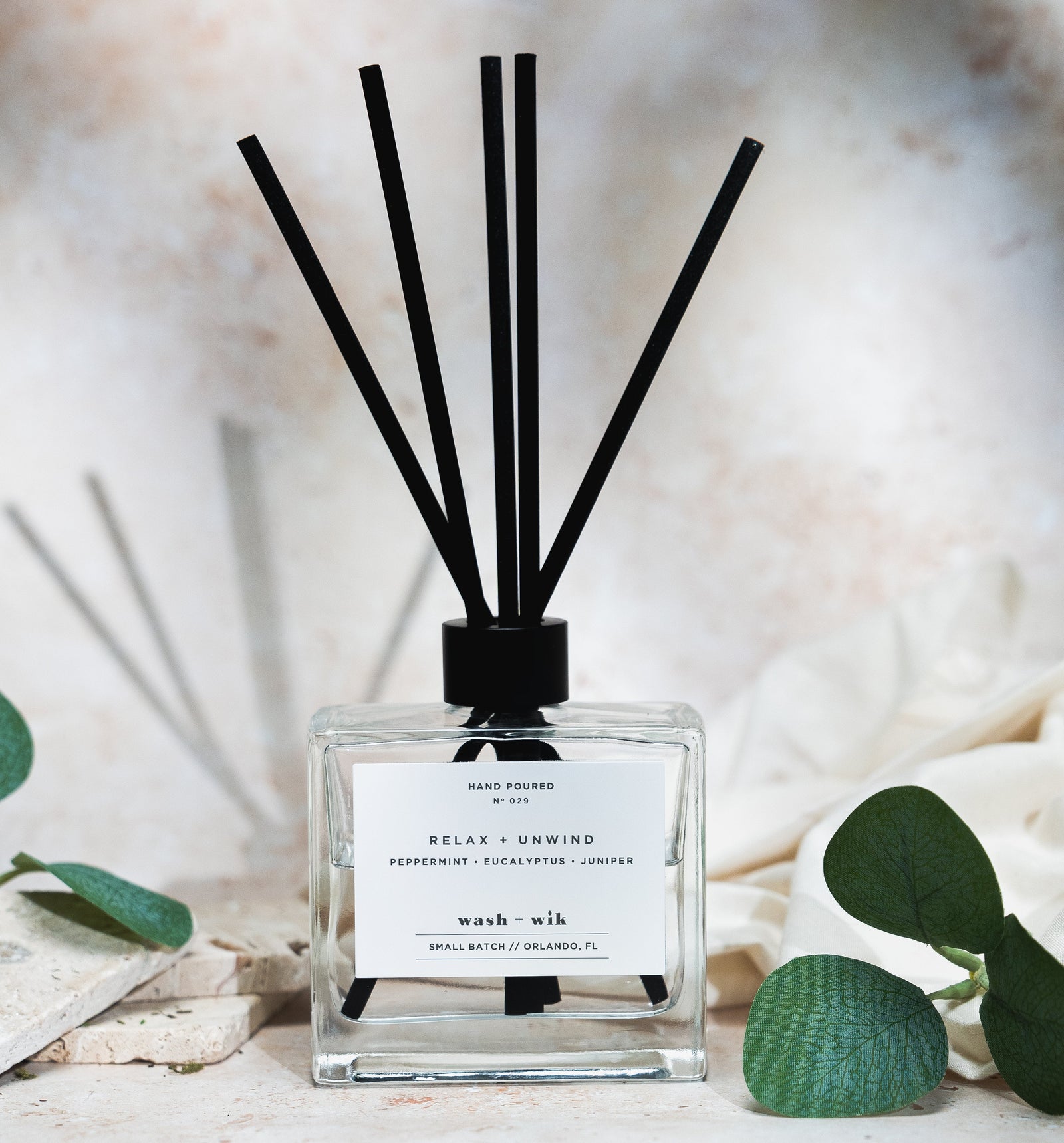 Diffuser with black sticks on a neutral background