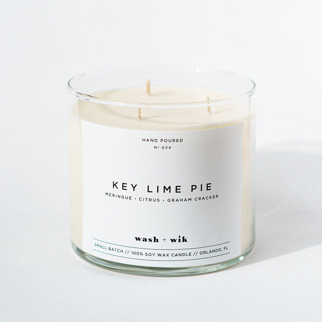 Candle labeled 'Key Lime Pie' with a white label on a white background