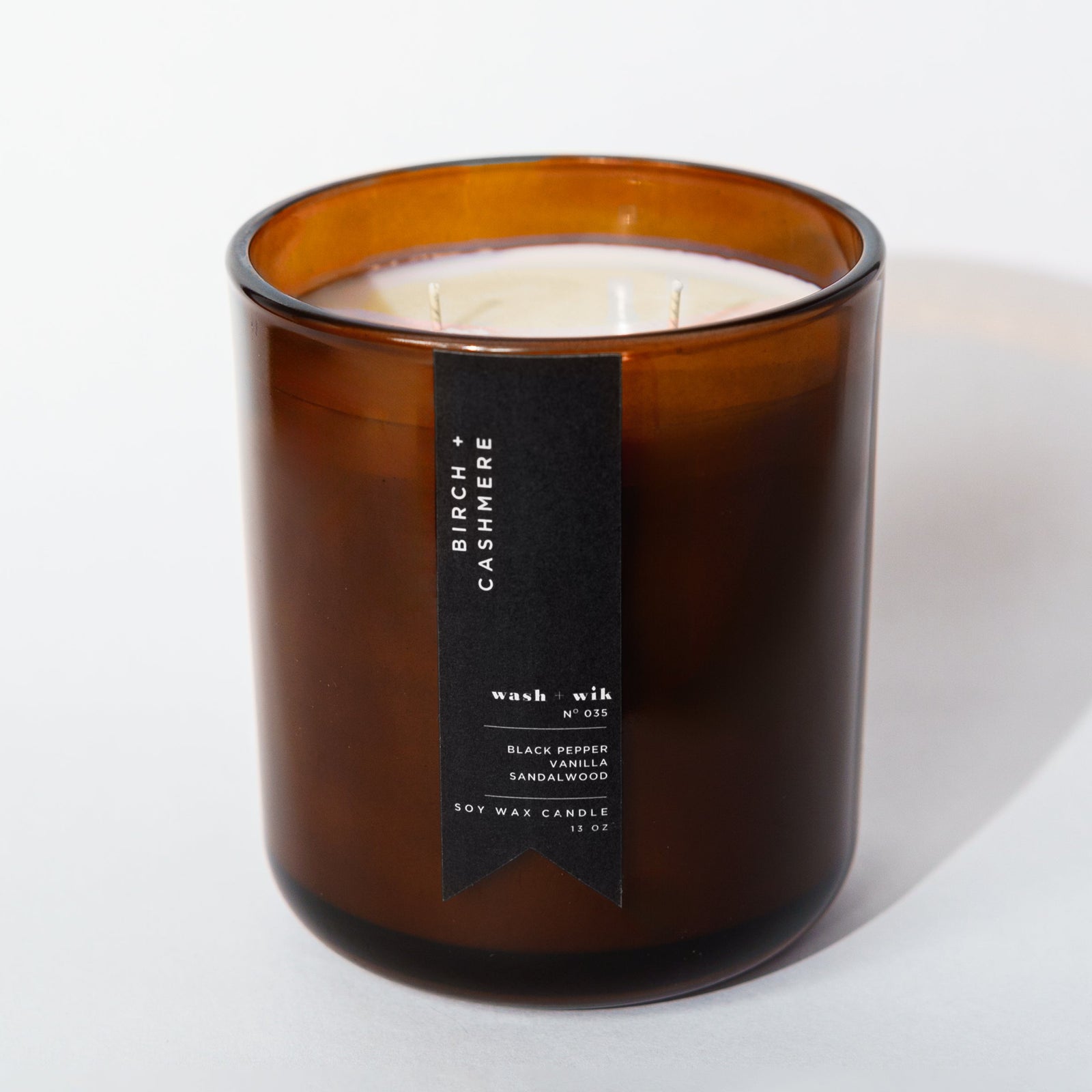 brown candle with black label and white background