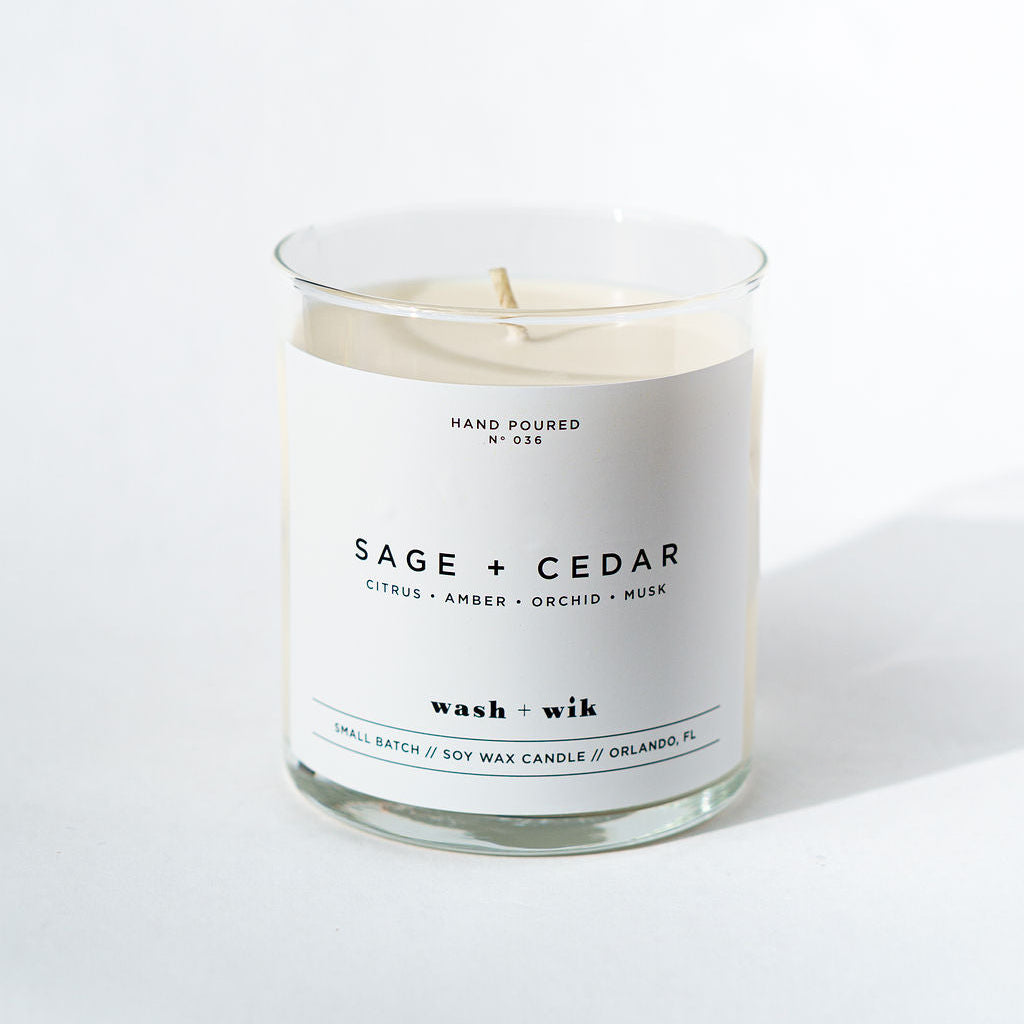 Sage + Cedar candle with a white label on a white background