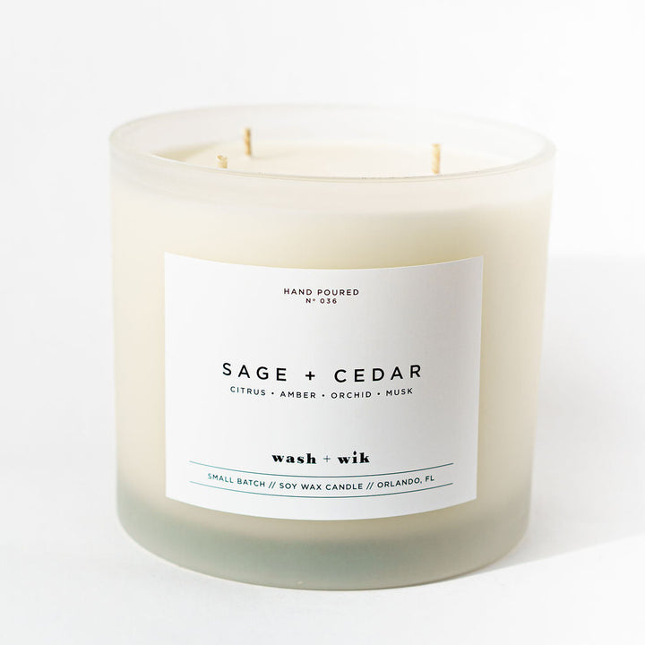 Sage and Cedar candle with a white label on a white background