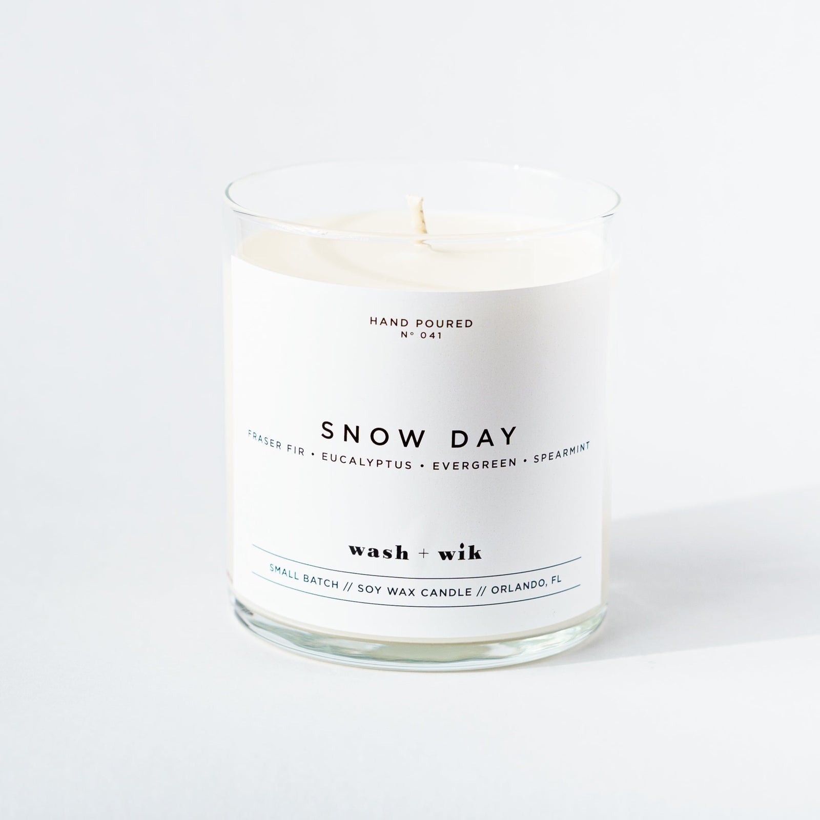 Candle labeled 'Snow Day' with a white label on a white background