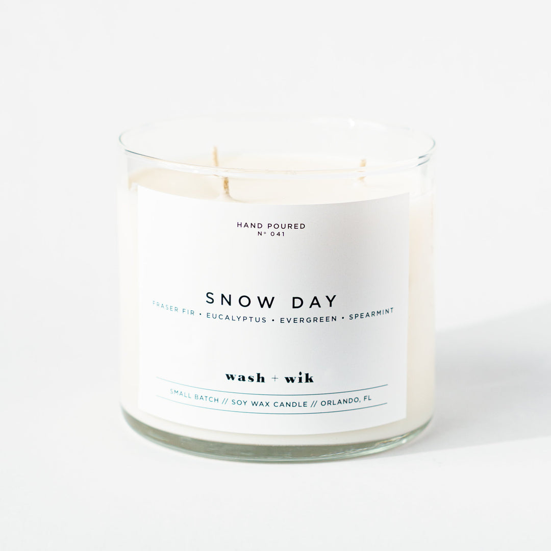Snow Day candle with a white label on a white background