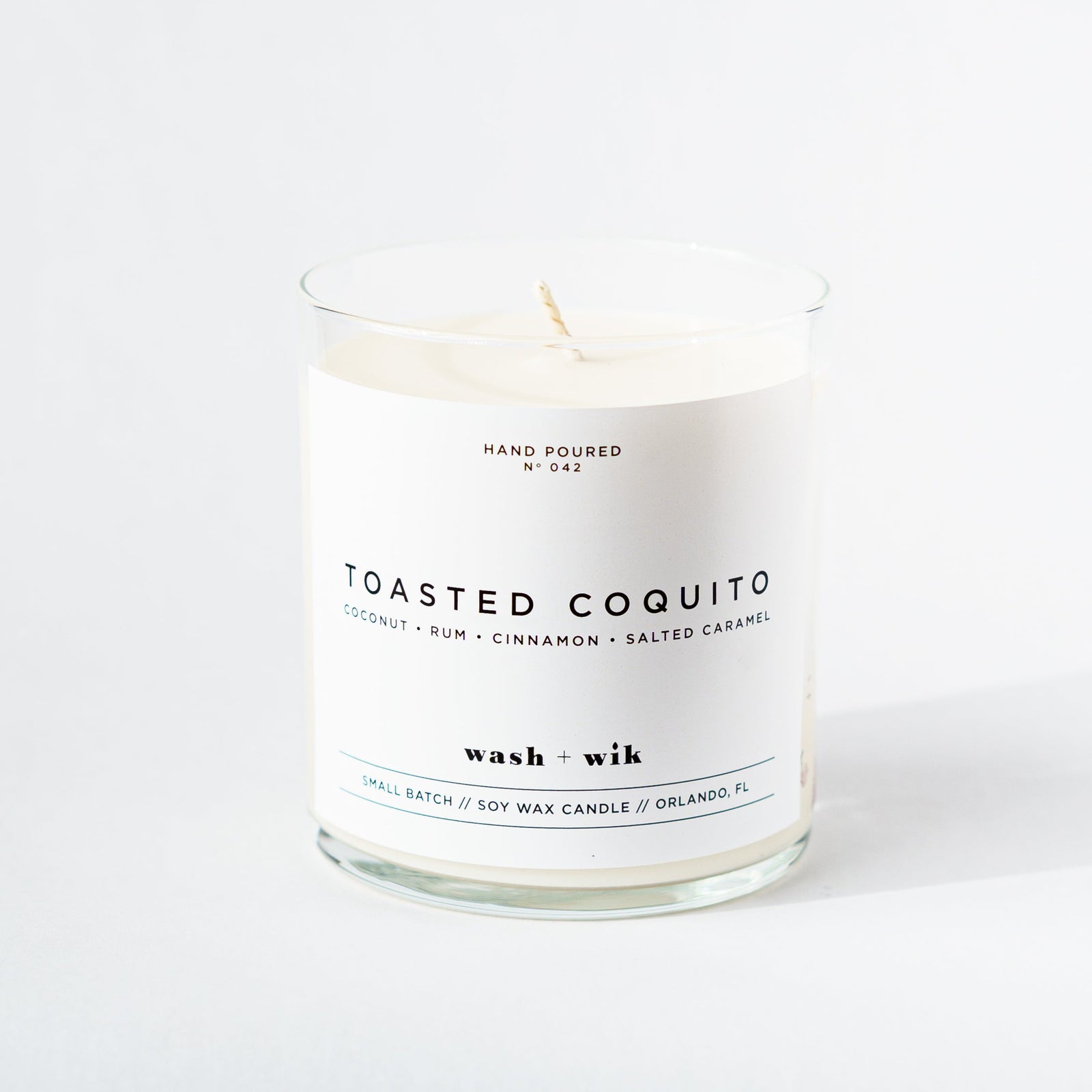 Candle labeled 'Toasted Coquito' on a white background
