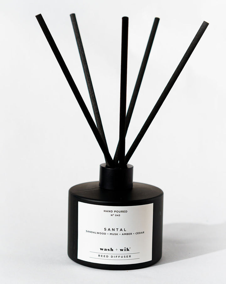 Black diffuser with sticks on a white background