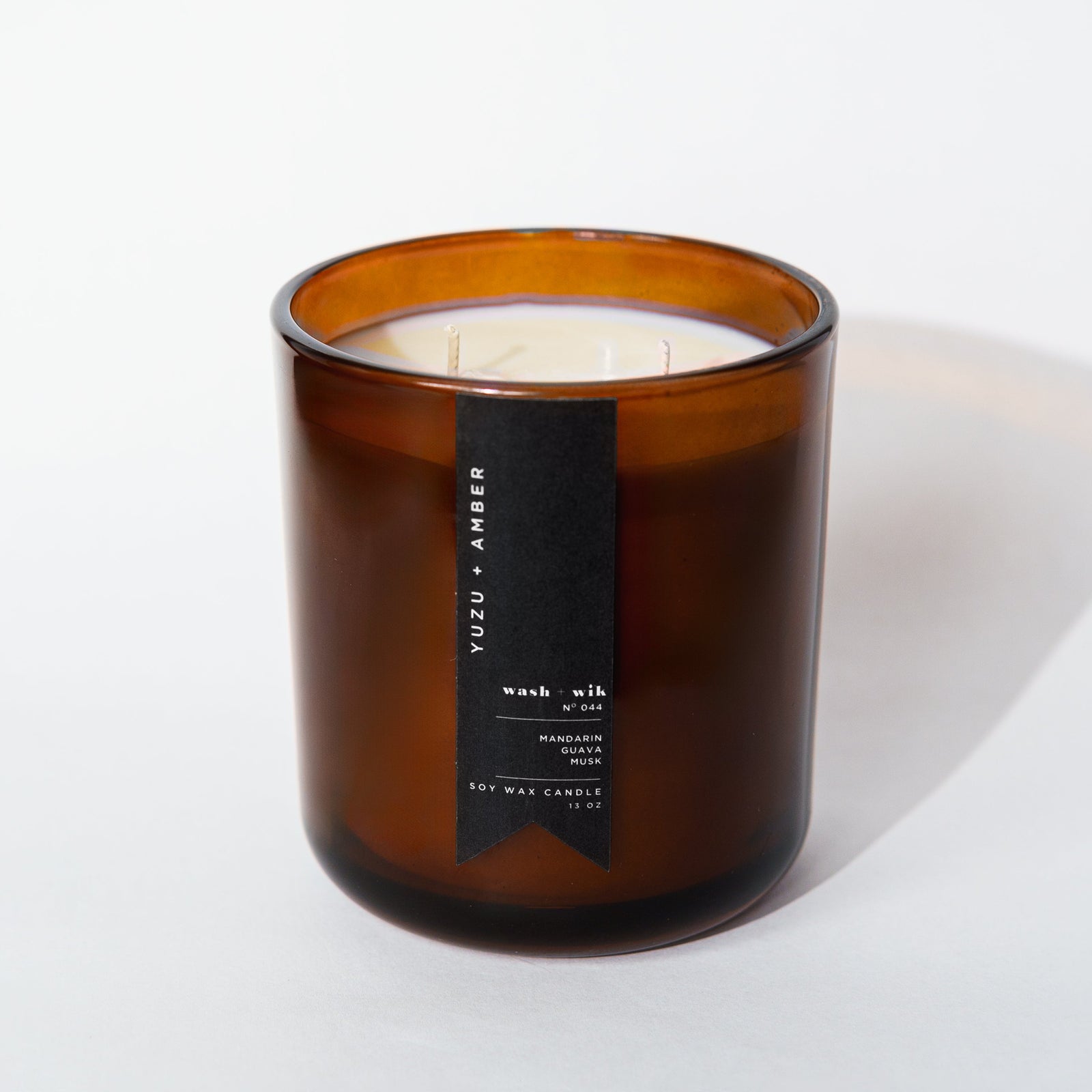 Brown candle with a label on a white background