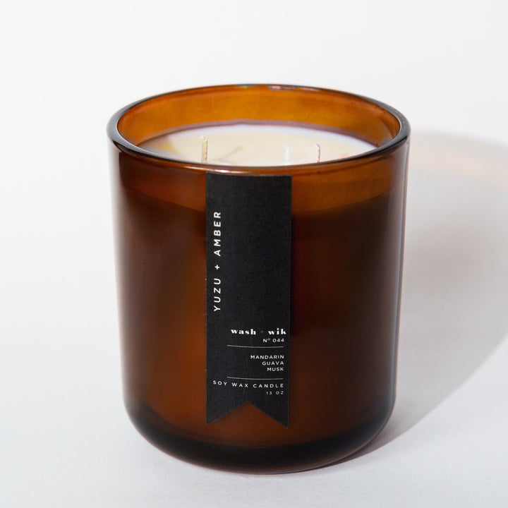 Brown candle with a label on a white background