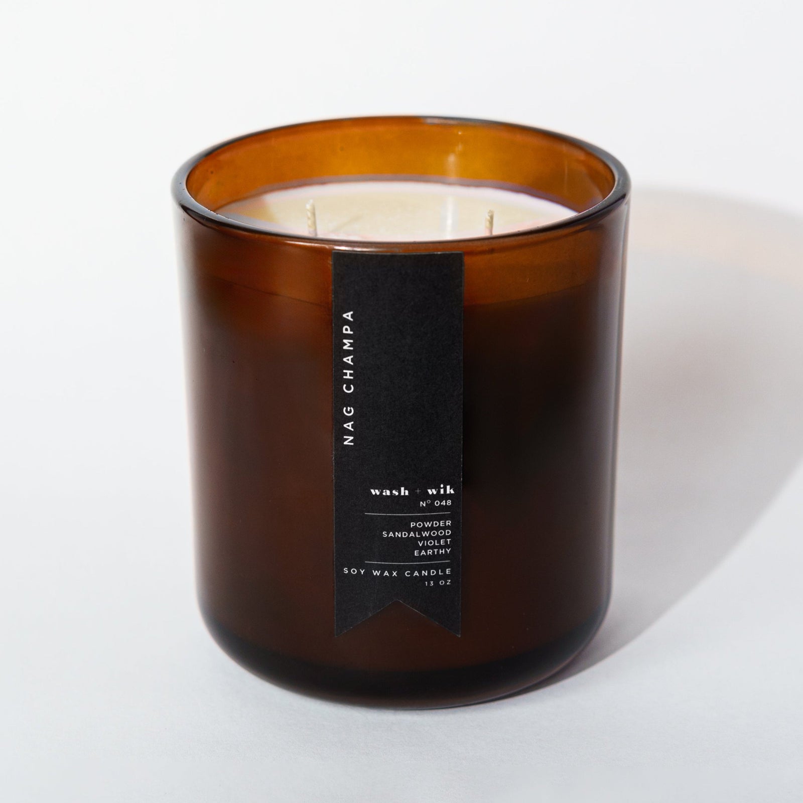 brown candle with black label and white background