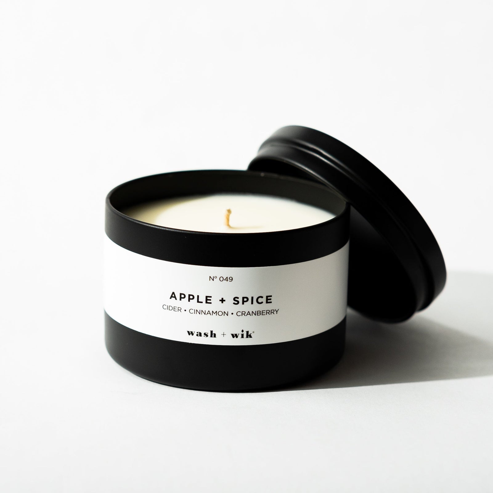 Black tin candle on white background