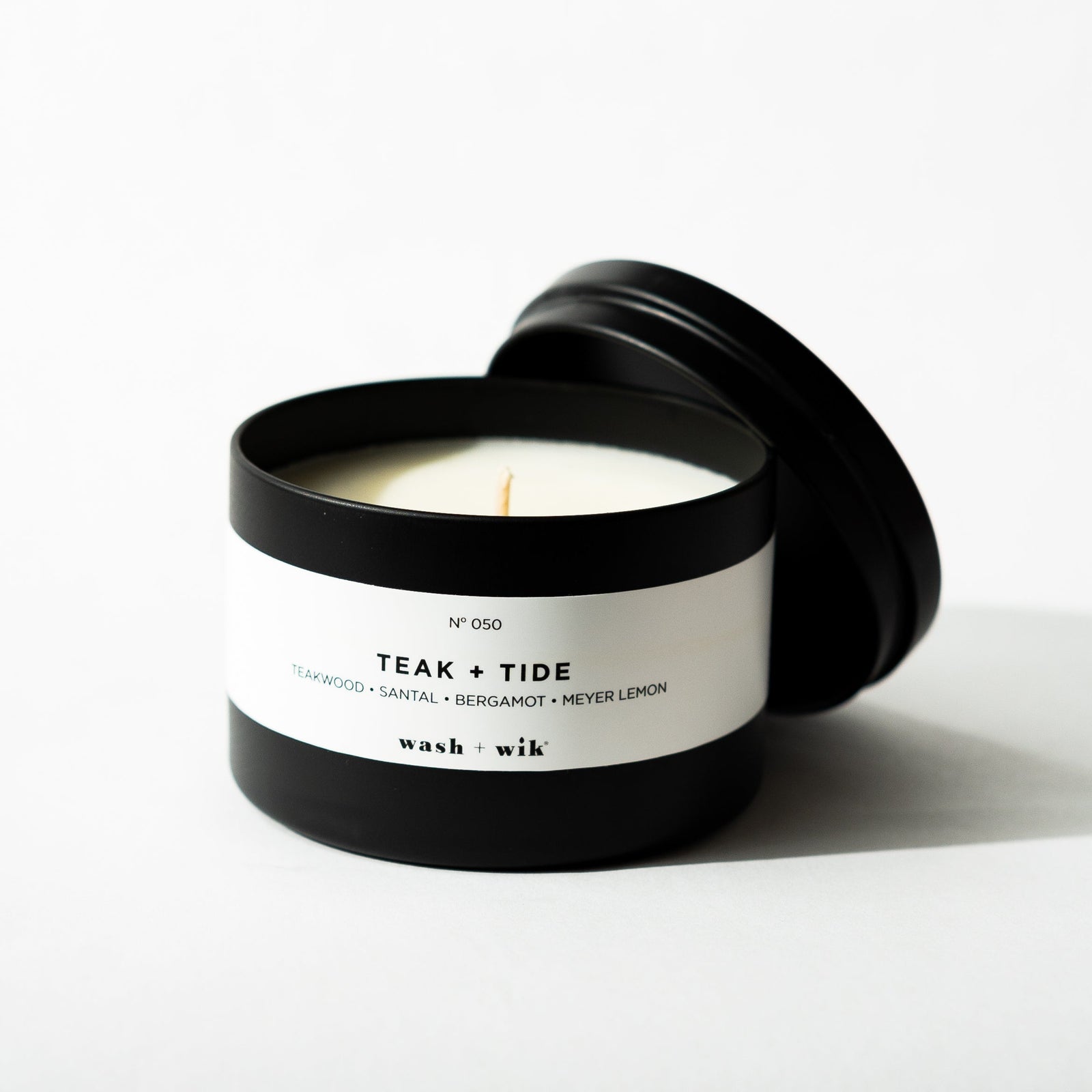 Black tin candle on white background