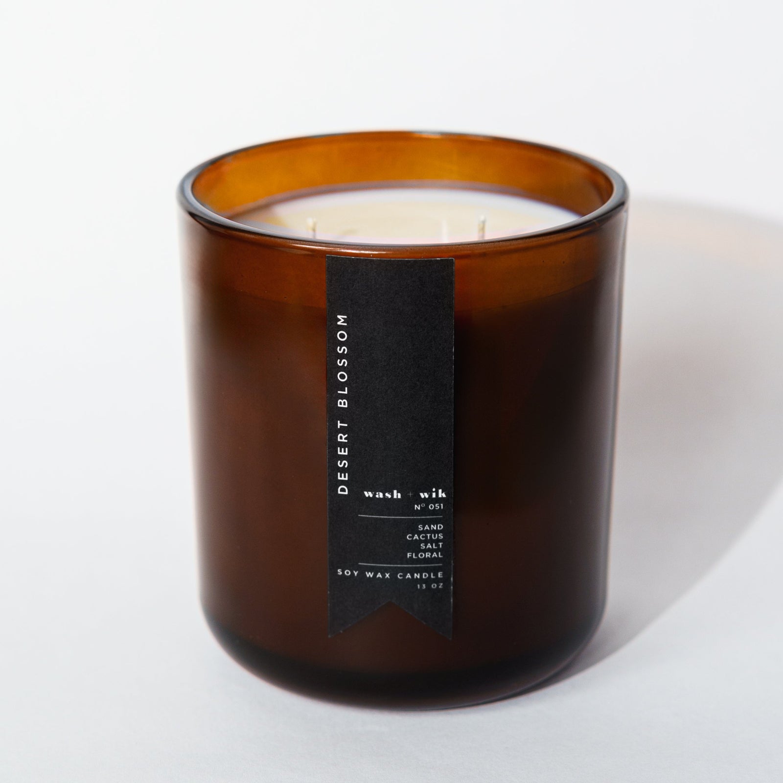 brown candle with black label and white background