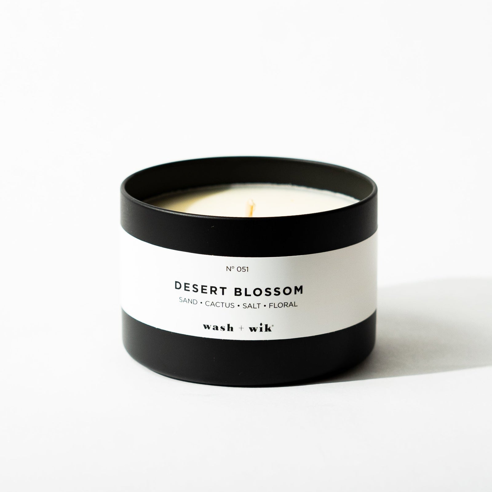 Black tin candle on white background