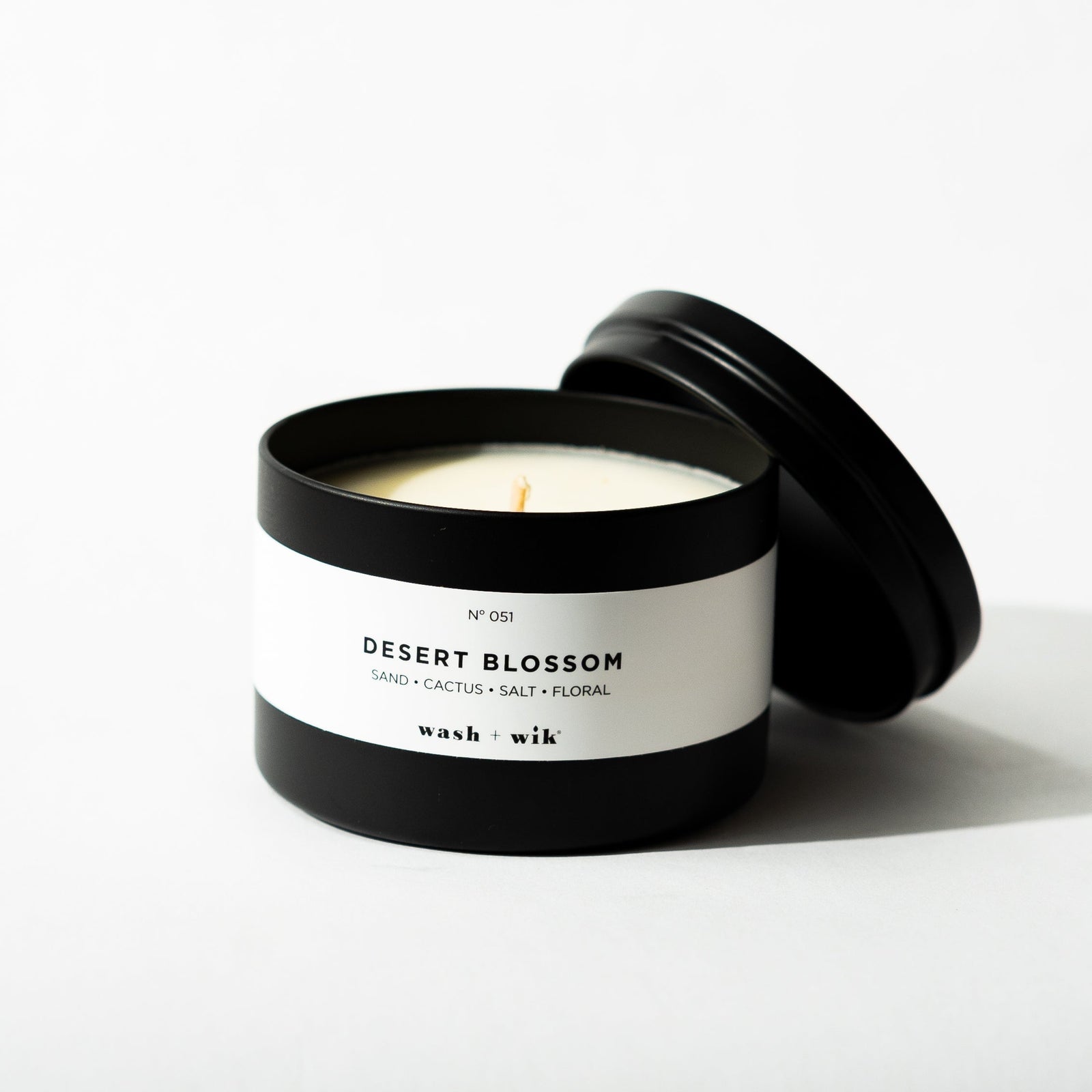 Black tin candle on white background