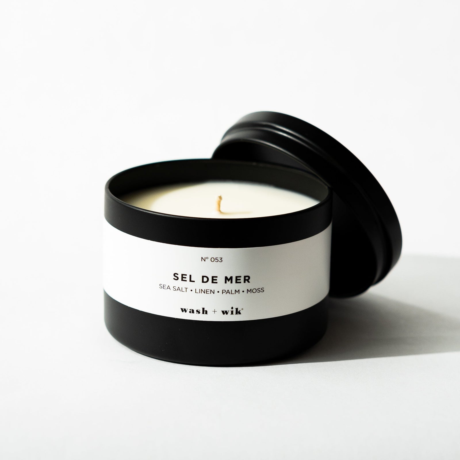 Black tin candle on white background