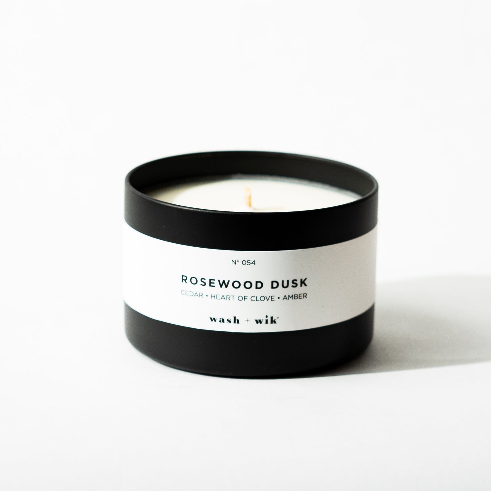 Black tin candle on white background