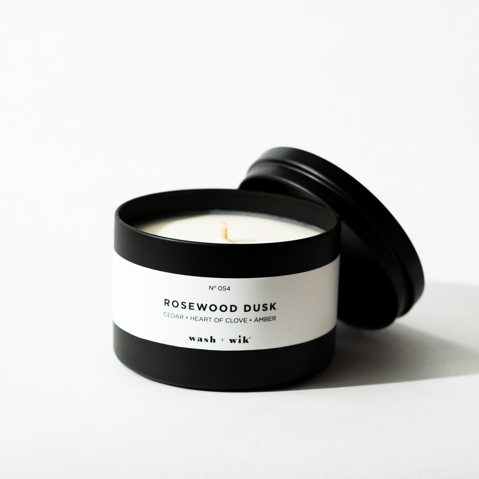 Black tin candle on white background