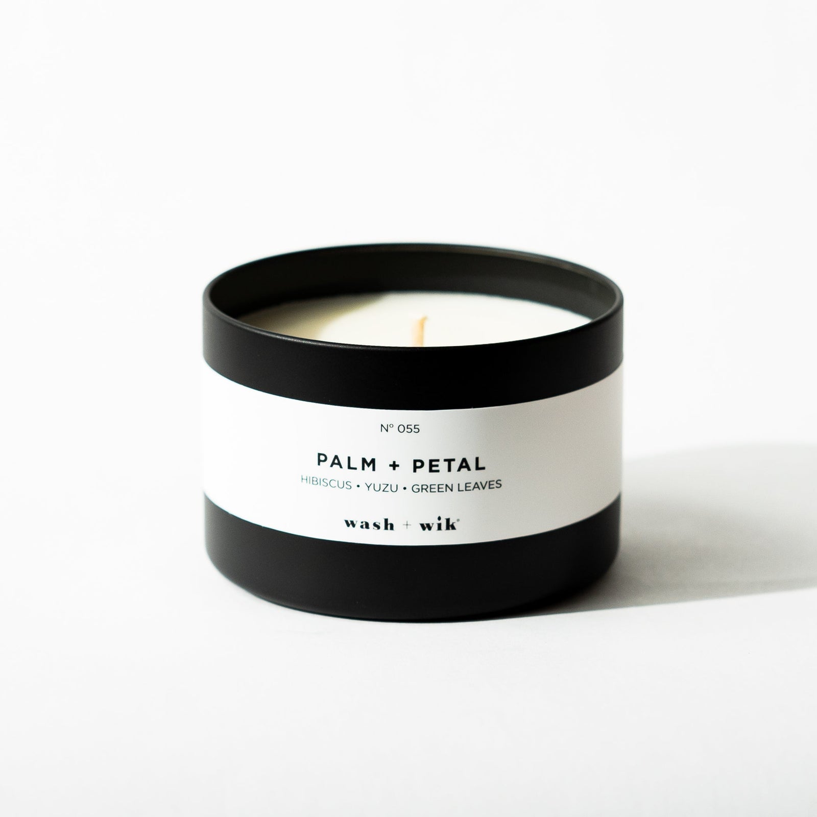 Black tin candle on white background