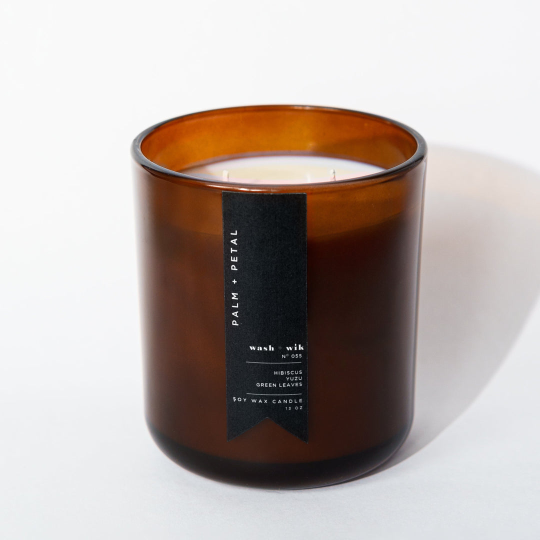 Brown glass candle with a label on a white background