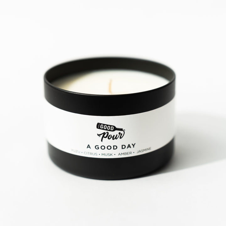 candle in black container with a white background