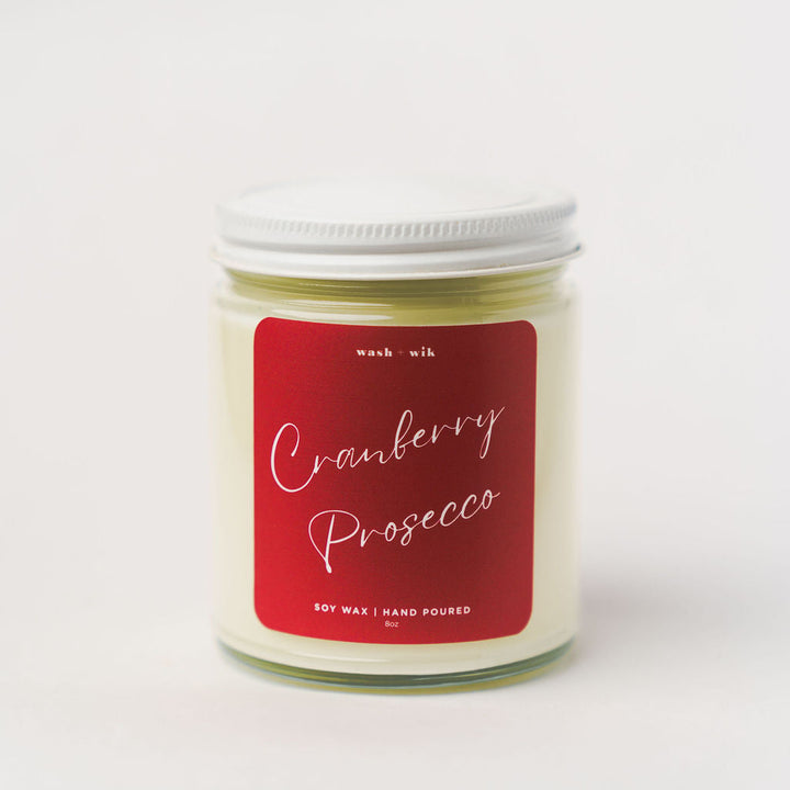 Candle jar with a red label on a white background