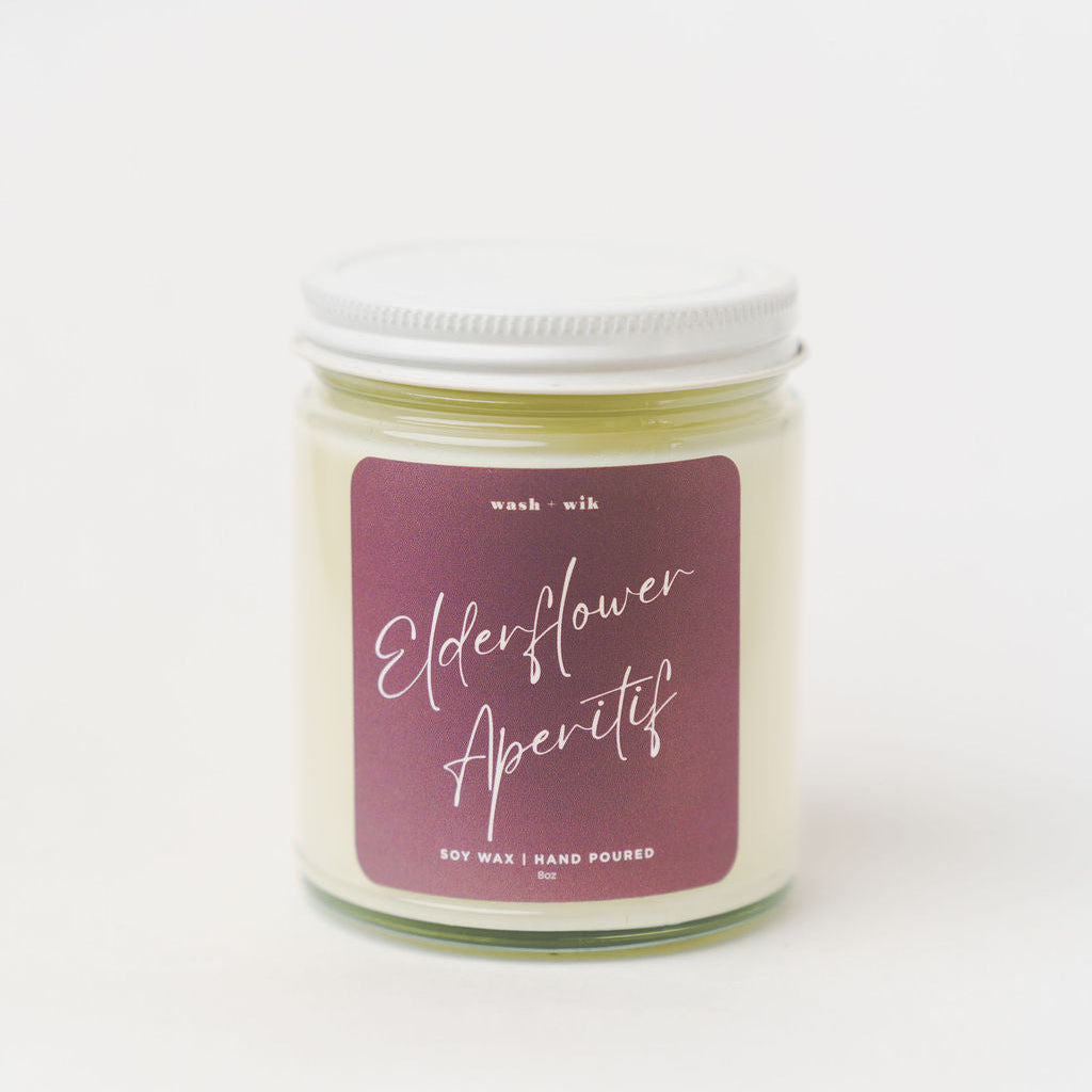 Candle jar with a purple label on a white background