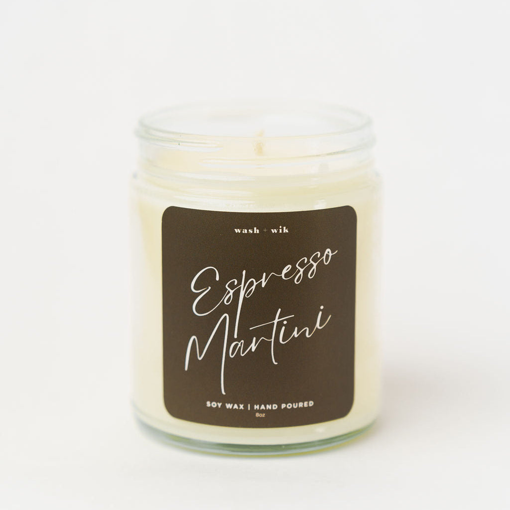 Candle in a glass jar with a label reading 'Espresso Martini' on a white background