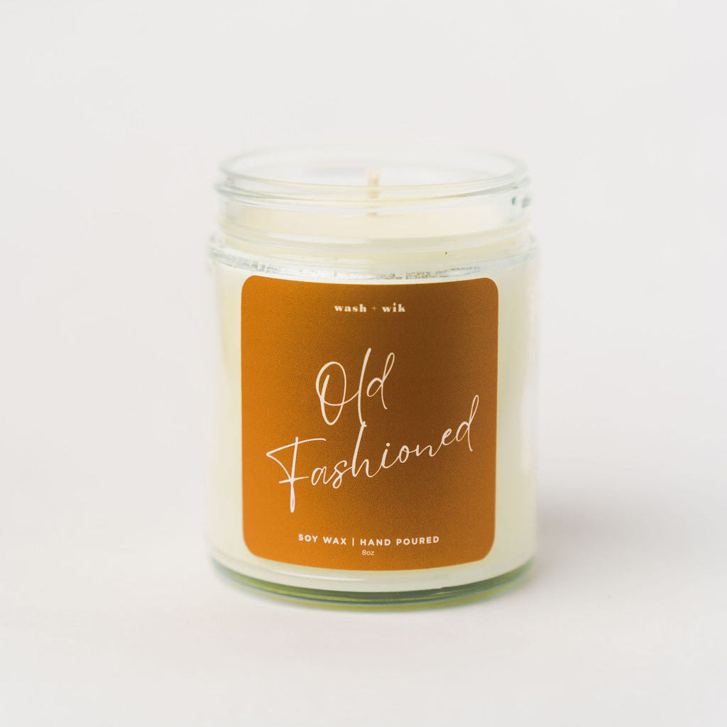 Candle with a brown label on a white background
