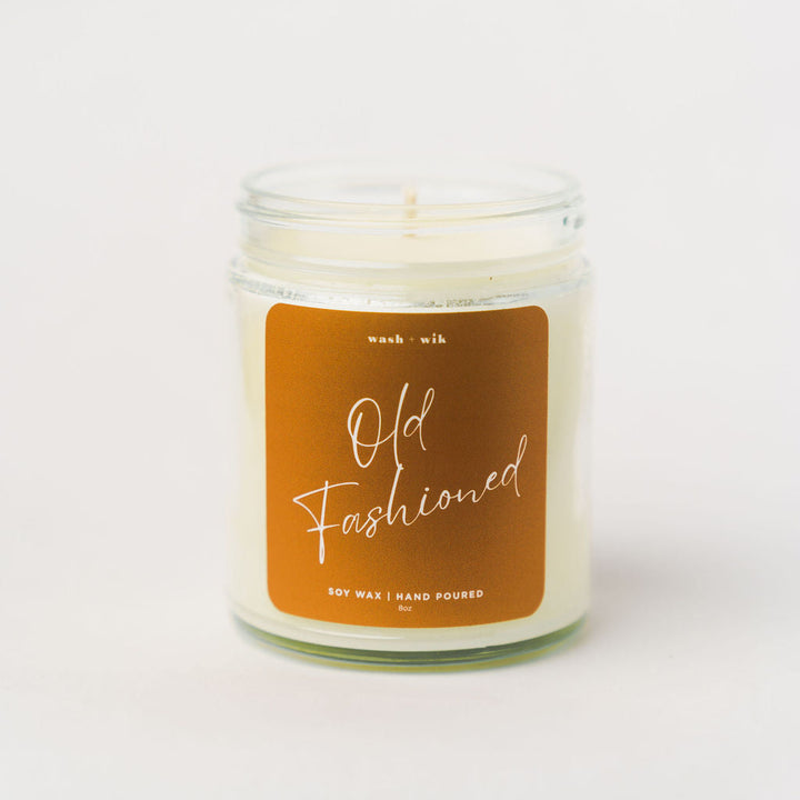 Candle with a brown label on a white background