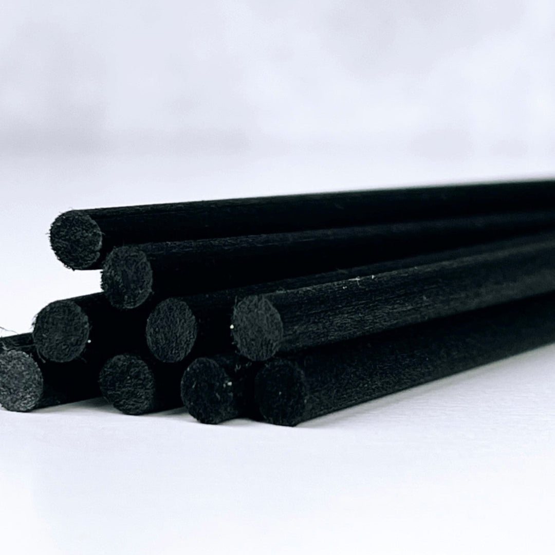 Black cylindrical objects on a white background