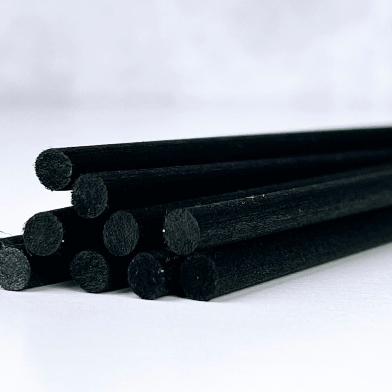 Black cylindrical objects on a white background