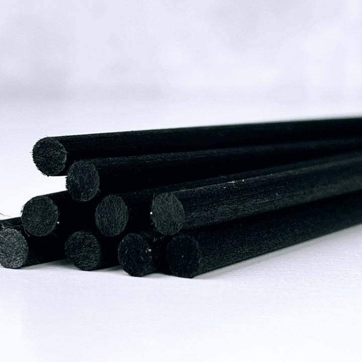 Black cylindrical objects on a white background