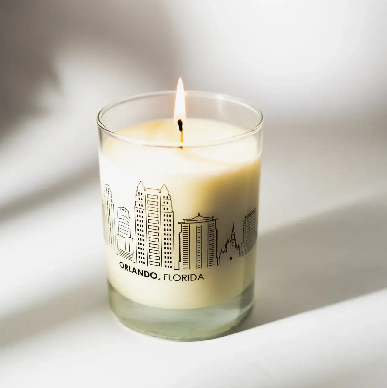 Candle with 'Orlando, Florida' design on a white background